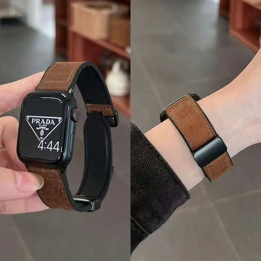 Smartwatch with brown leather strap held in hand and worn on wrist, brand logo visible.