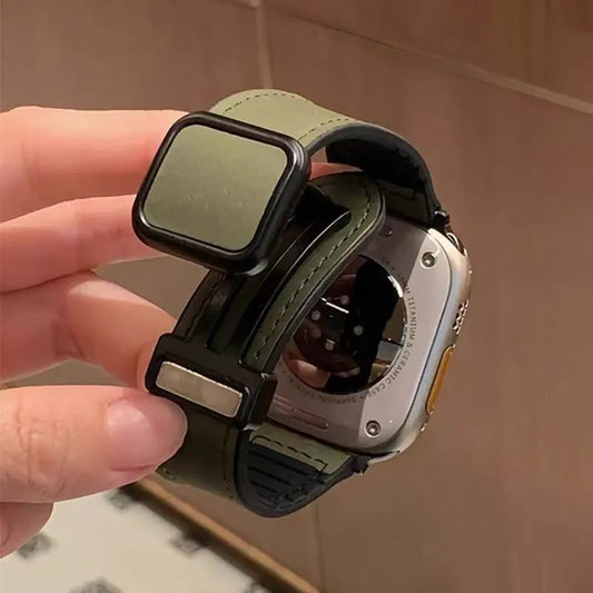 Smartwatch with a green band being held by a hand against a neutral background