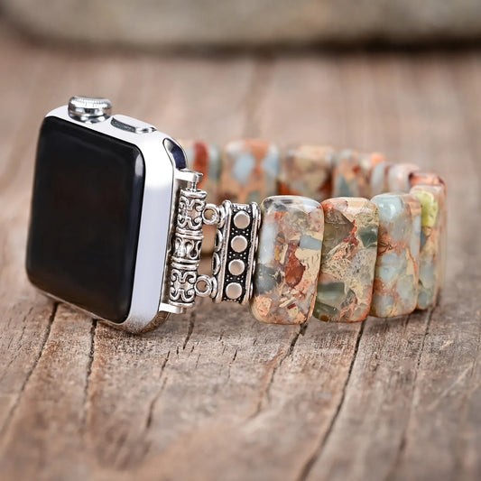 Smartwatch with a decorative band on a wooden surface