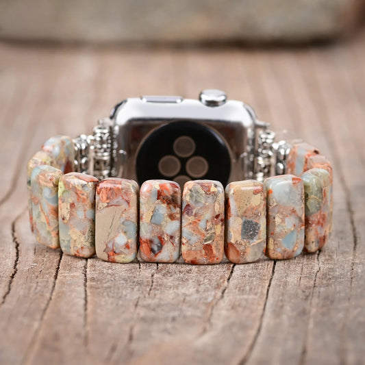 Watch with a colorful beaded band on a wooden surface