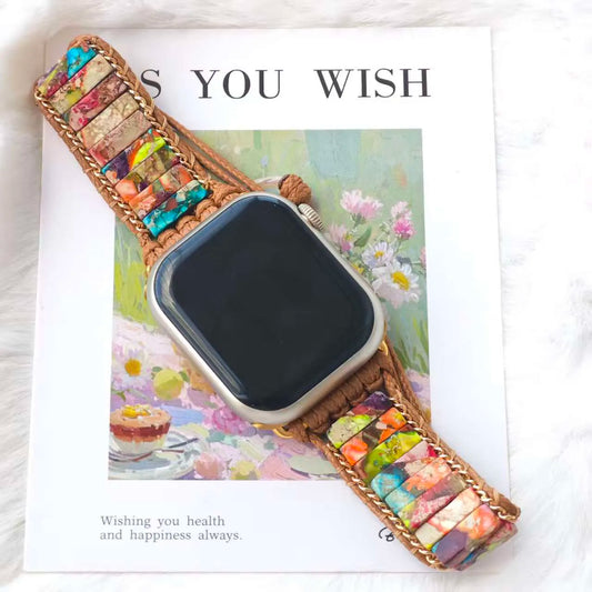 Smartwatch with a colorful braided band on a magazine cover with floral design