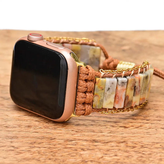 Smartwatch with a decorative band on a wooden surface