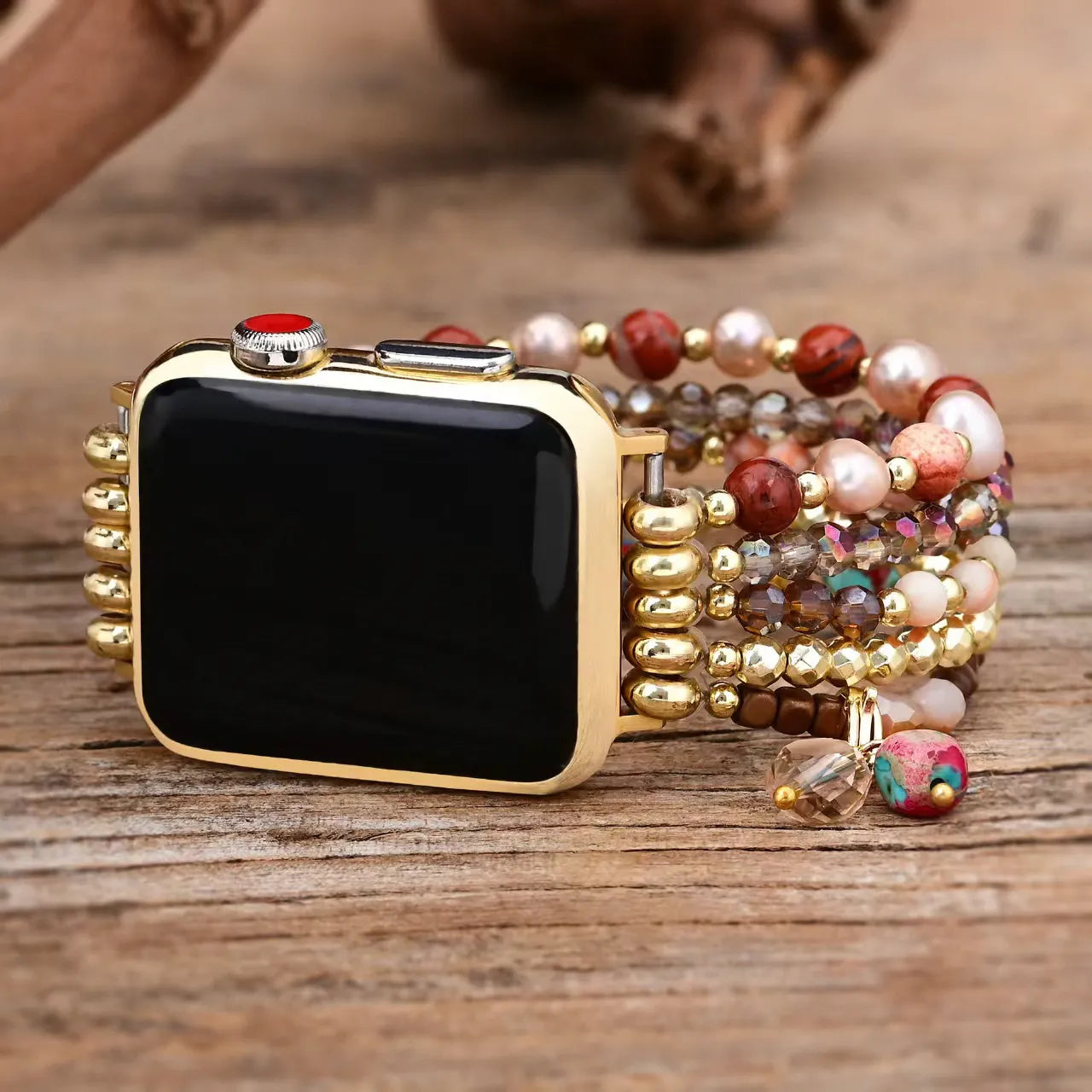Smartwatch with a decorative beaded band on a wooden surface