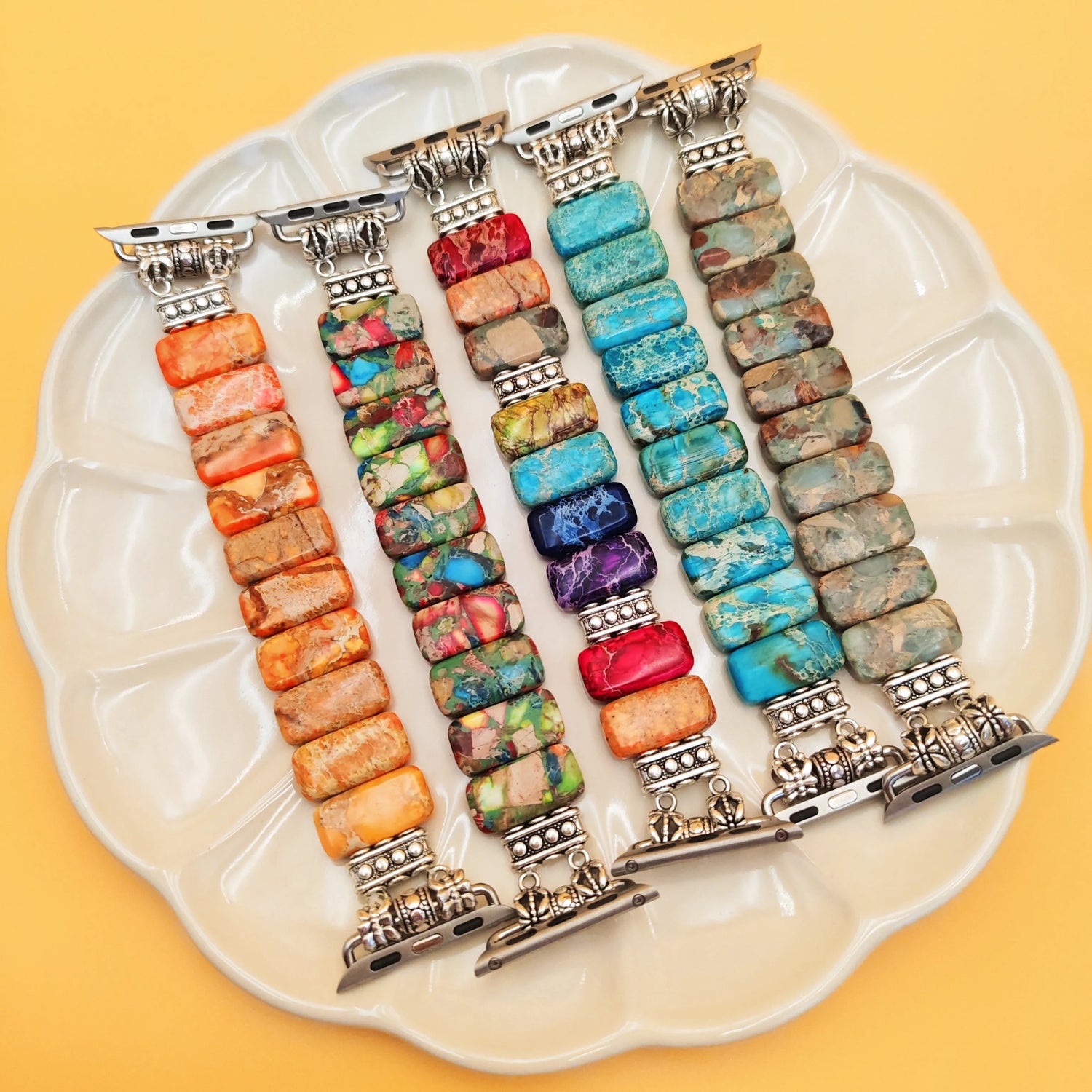 Colorful beaded bracelets on a white plate with a yellow background