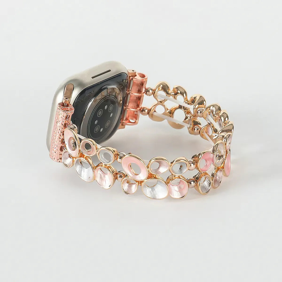 Smartwatch with a decorative rose gold and pink watch band on a light gray background