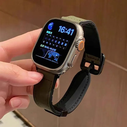Smartwatch with a black strap held by a hand against a neutral background