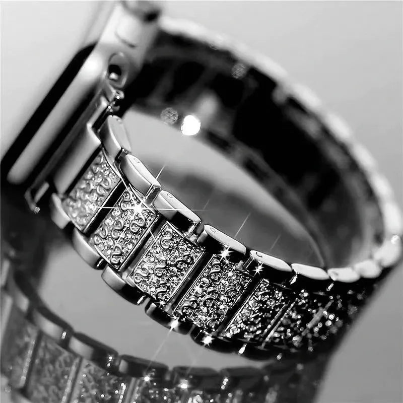 Close-up of a silver bracelet with diamond accents on a reflective surface.