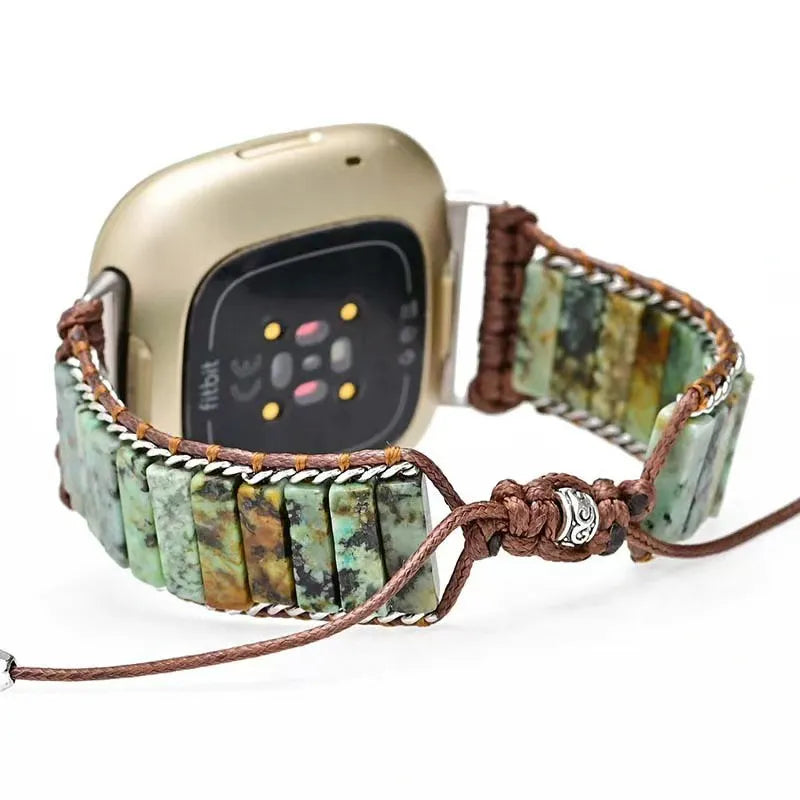 Smartwatch with a decorative stone bracelet on a white background