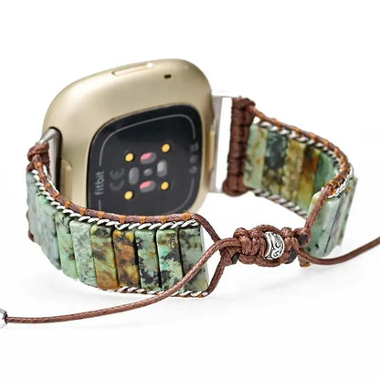 Smartwatch with a decorative stone bracelet on a white background
