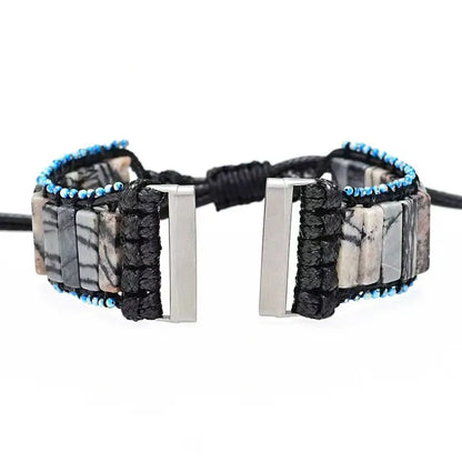 Bracelet with stone-like pattern and blue beads on a white background