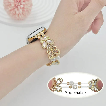 Gold bracelet with butterfly design on a wrist, with a close-up inset showing the stretchable feature.