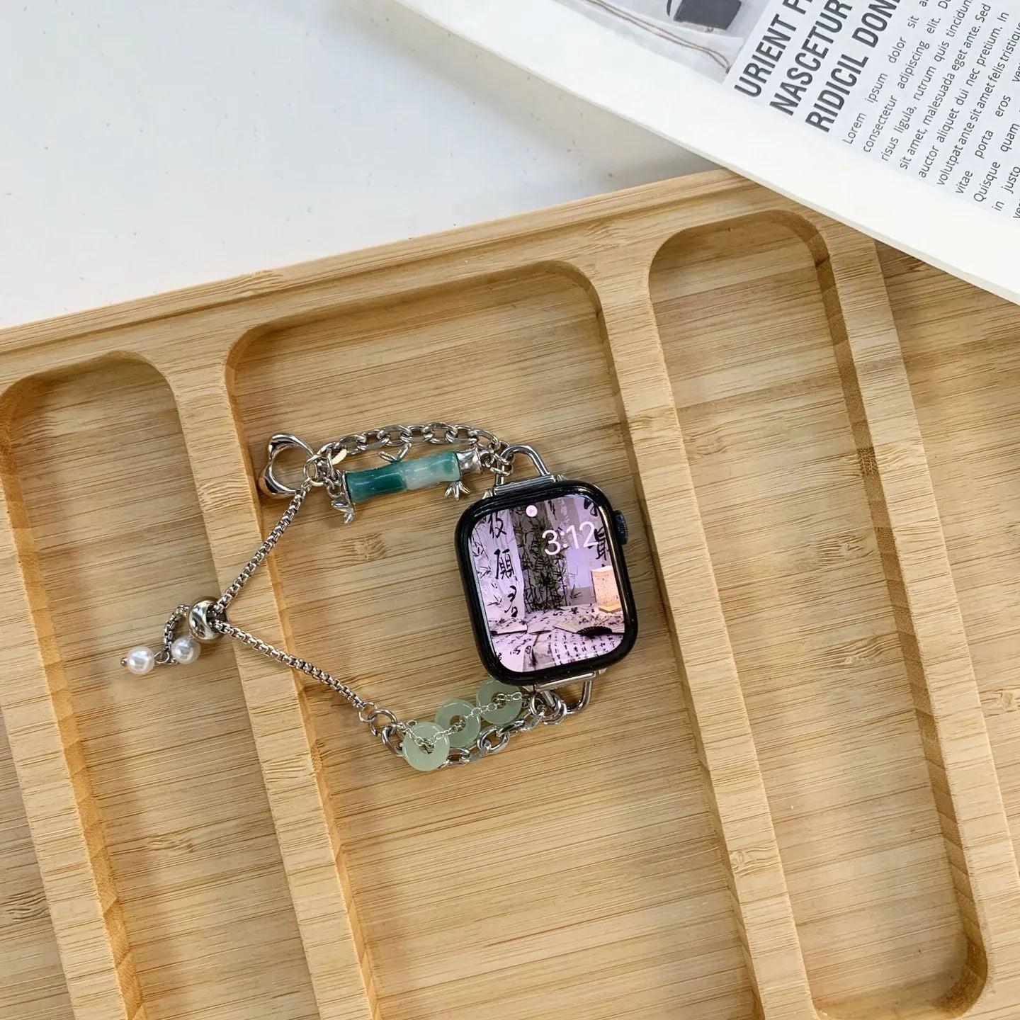 Smartwatch with a decorative band on a wooden tray