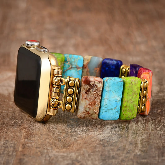 Smartwatch with a colorful stone bracelet on a wooden surface